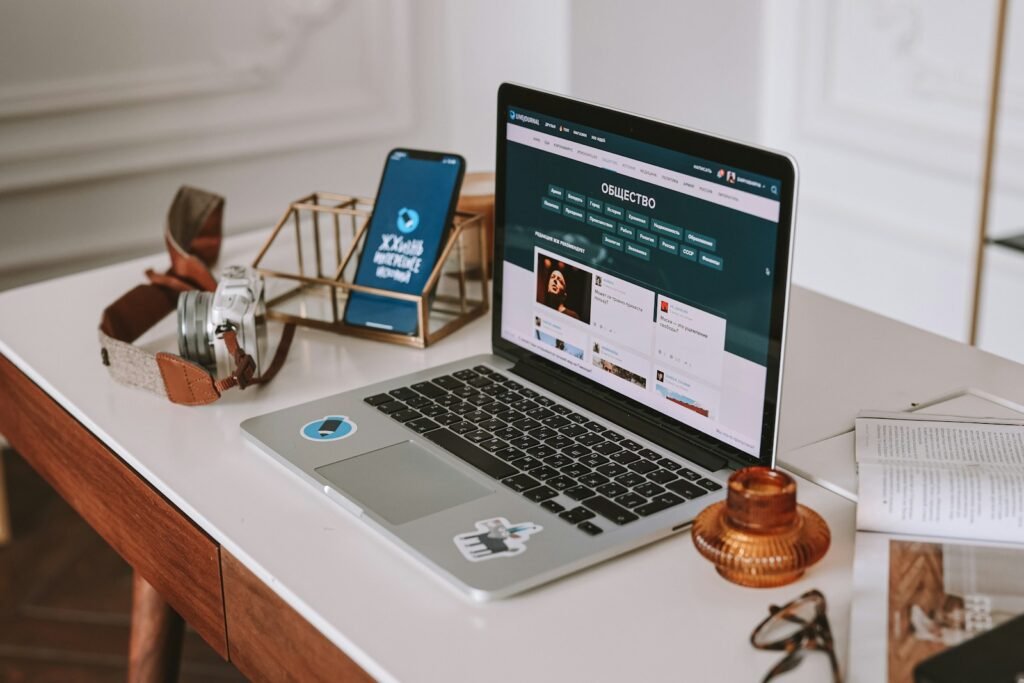 a laptop computer sitting on top of a wooden desk